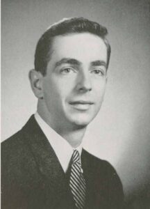 Richard Garnett '56 is pictured in a suit and tie for his senior yearbook photo