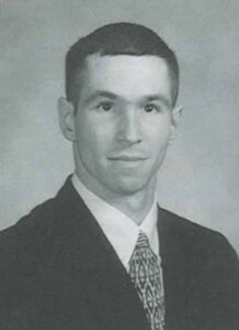 William Yinger is pictured in a dark suit and tie for his senior yearbook photo