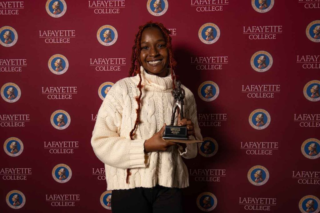 In spring of 2023 Peters received the Unsung Hero award at the annual Aaron O. Hoff Awards. Jada is holding an award and is wearing a white sweater. 